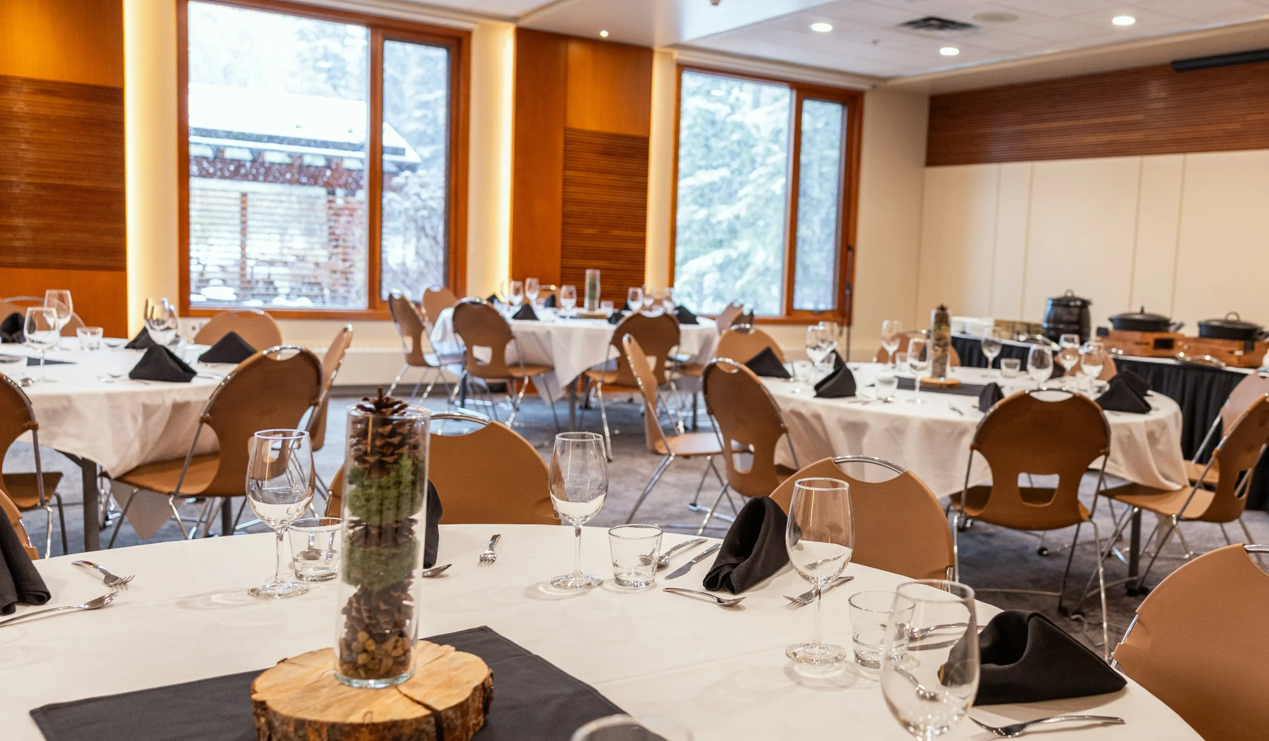 A group of business professionals have a meeting in a bright, airy room at the Juniper Hotel