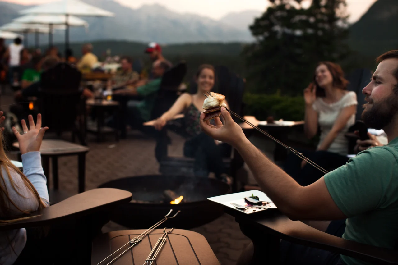 A group enjoy s'mores on the Juniper Bistro patio