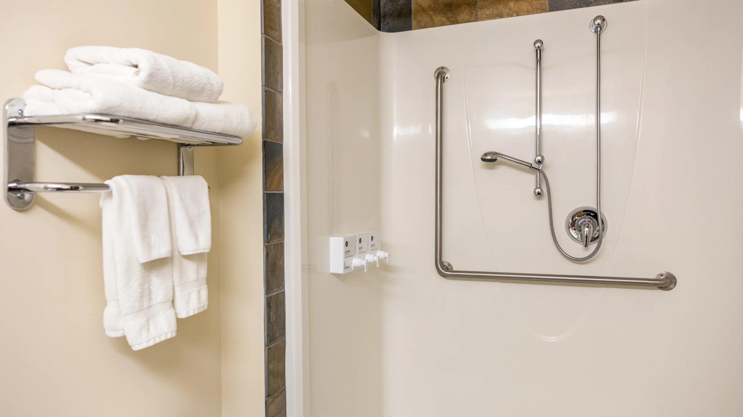 The Queen Accessible room at the Juniper features a step-free shower and wide spaces between the bed and furniture in a comfortable room.