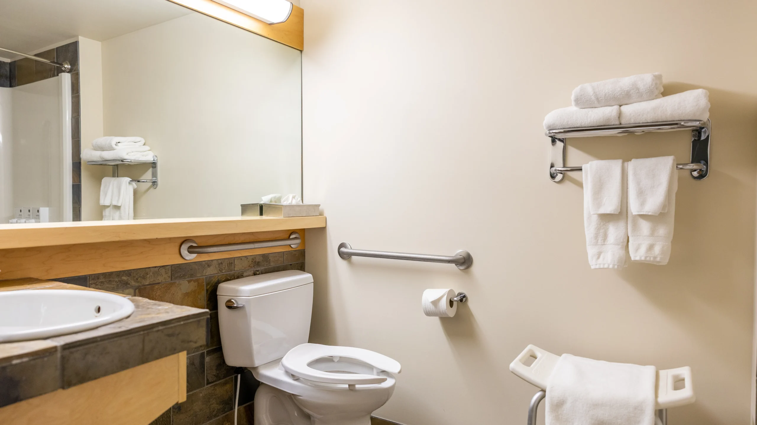 The Queen Accessible room at the Juniper features a step-free shower and wide spaces between the bed and furniture in a comfortable room.