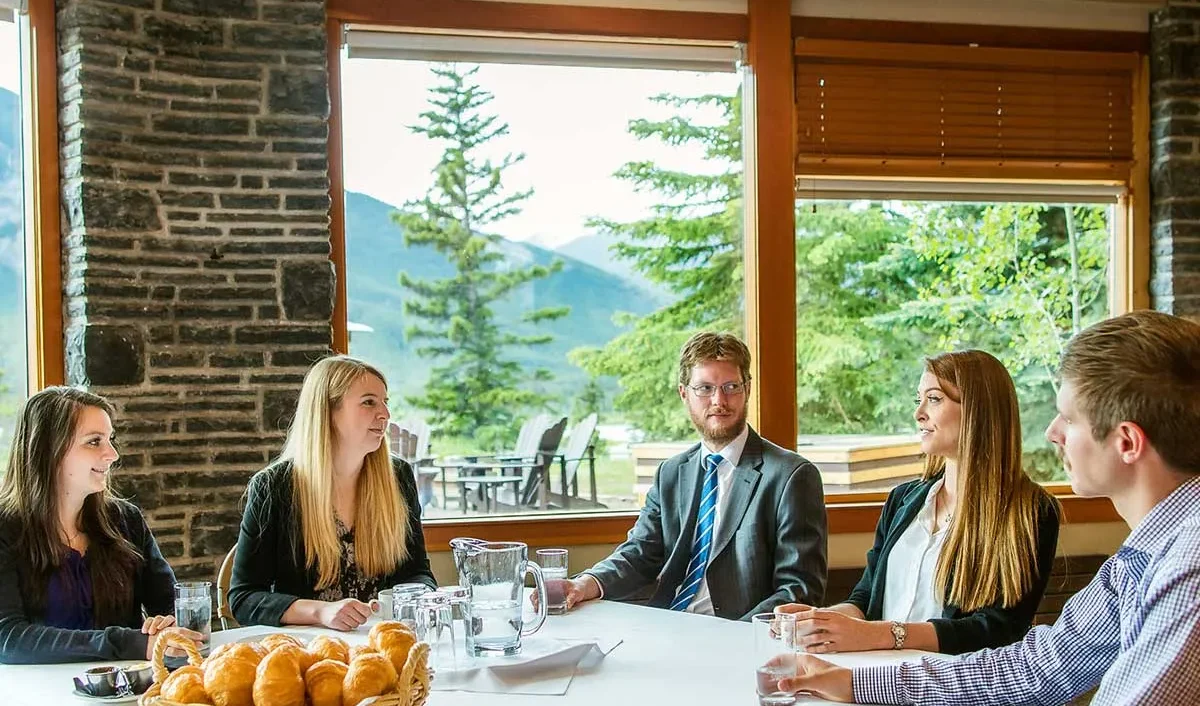 A group in the Vermilion Room - a bright, airy meeting space at the Juniper