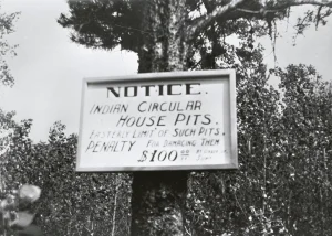 Black and white image of sign reading - Notice, Indian Circular House Pits. Easterly Limit of Such Pits. Penalty for Damaging them $100